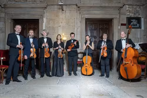 Musicians with string instruments at Casanova Opera Concert in the historic Palace of Prisons setting.