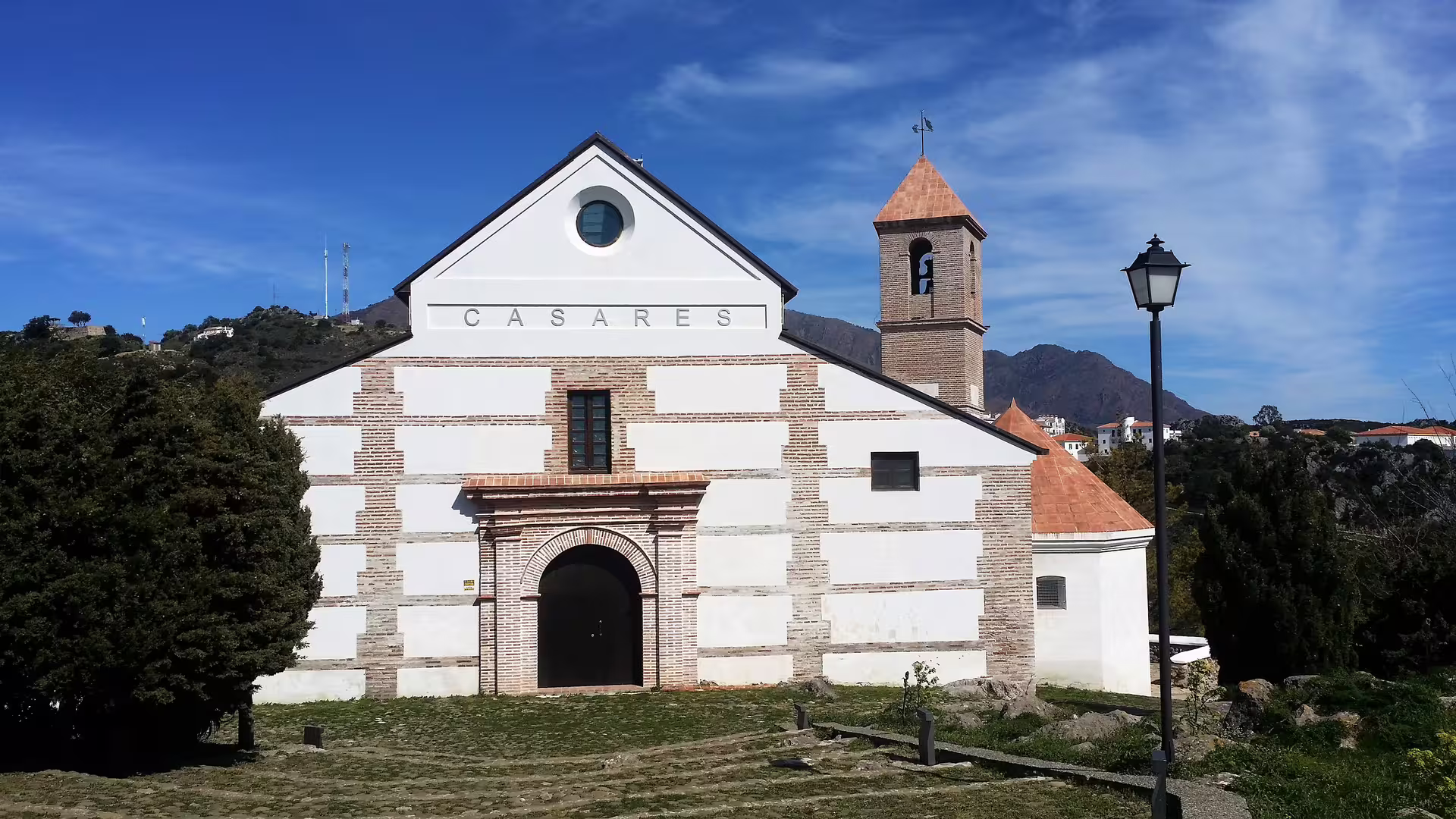 Facade of Casares church and bell tower with mountain views, Casares and Estepona private tour with hotel pick-up