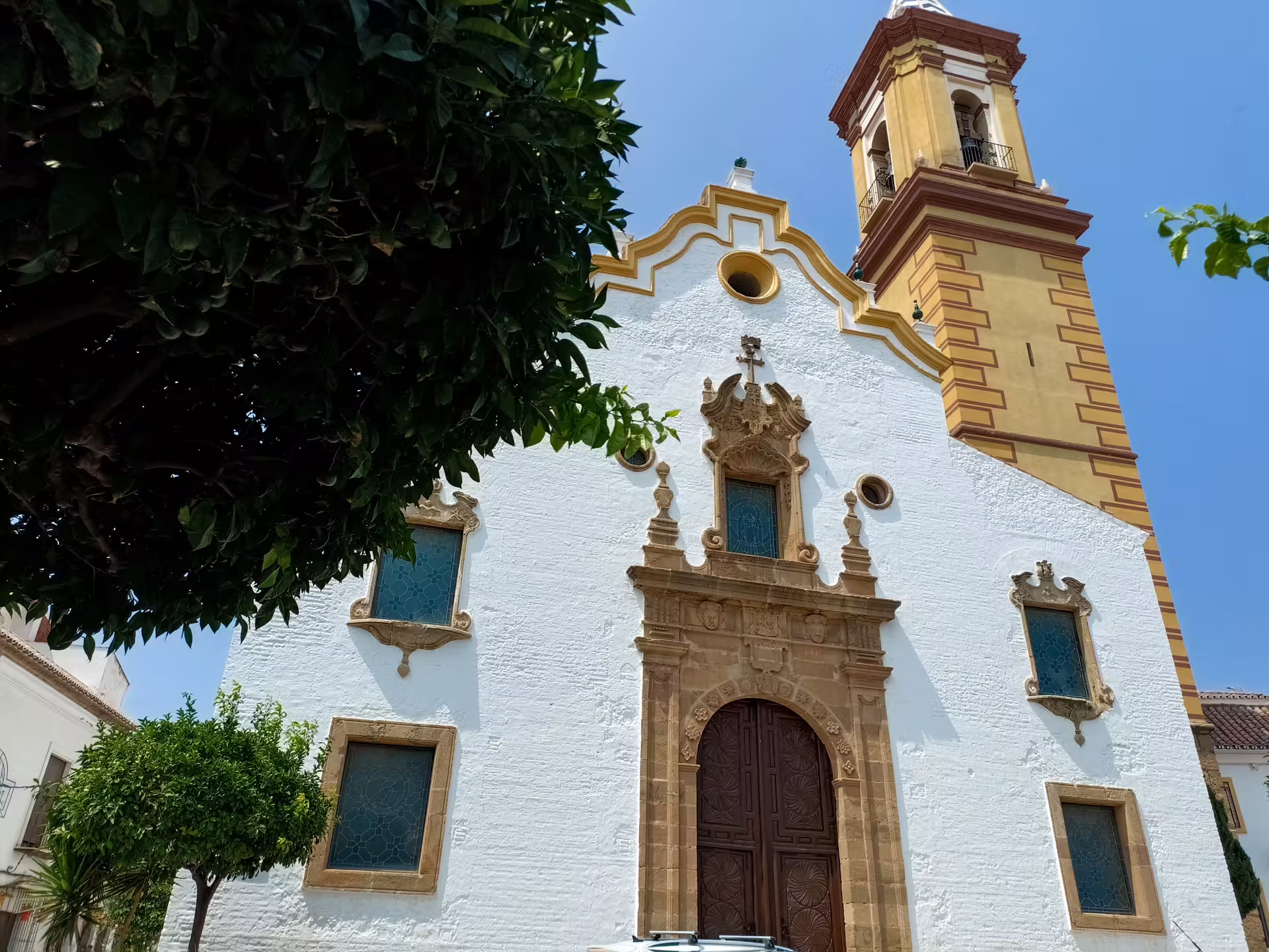 Casares whitewashed church facade and bell tower, Andalusia, on private trip with hotel pick-up from Estepona