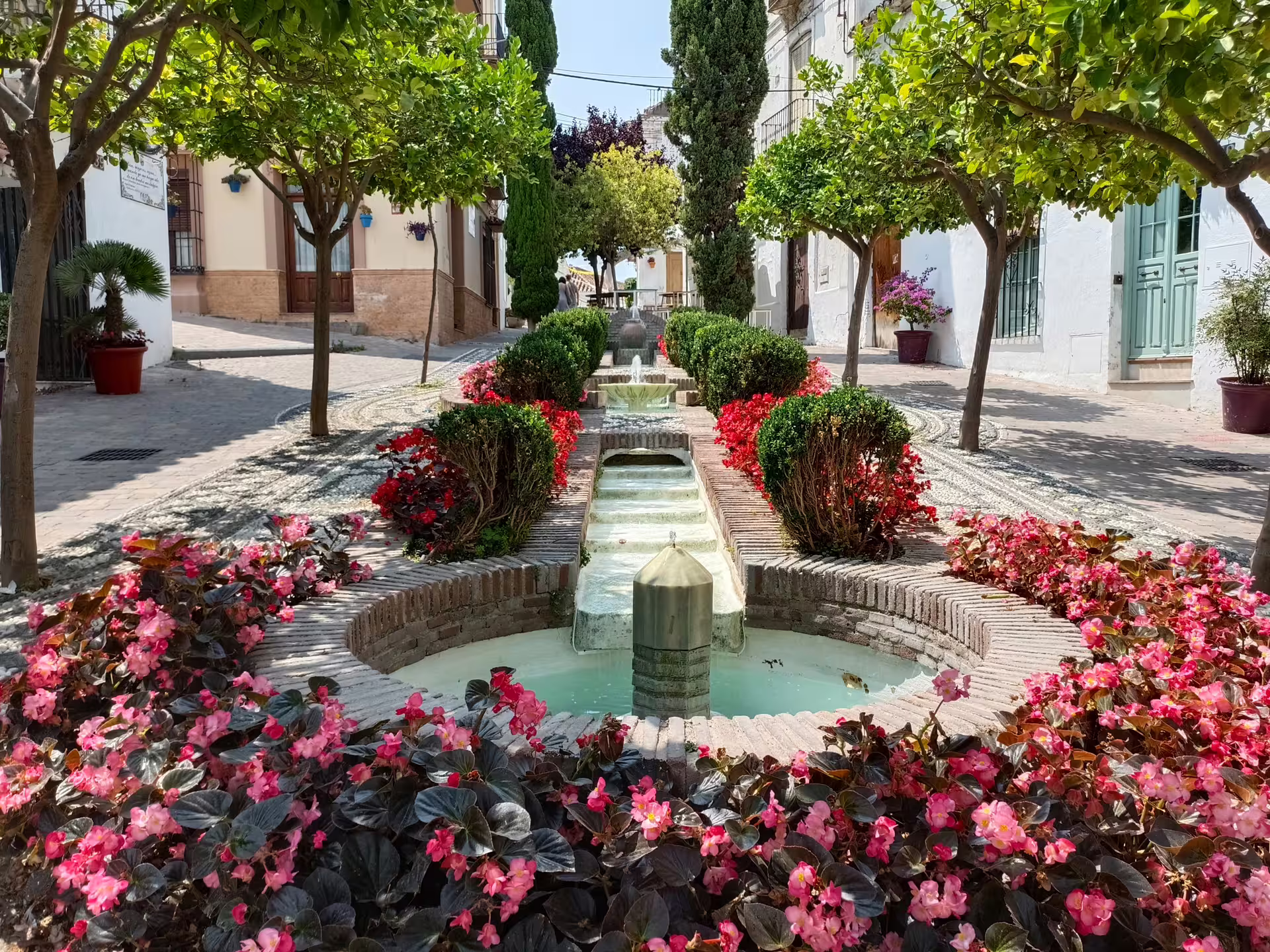 Flower-lined fountain street in Casares old town on a private Casares and Estepona day trip with hotel pick-up