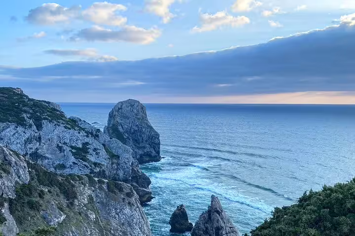 Scenic cliffs and Atlantic Ocean vista at sunset in Cascais, ideal for exploration on a private jeep tour.