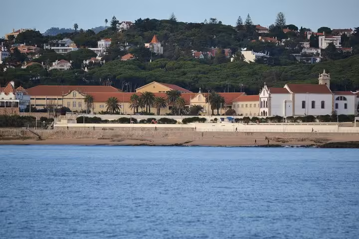Cascais coastline view from private 2h sailing cruise, calm Atlantic waters and historic waterfront buildings
