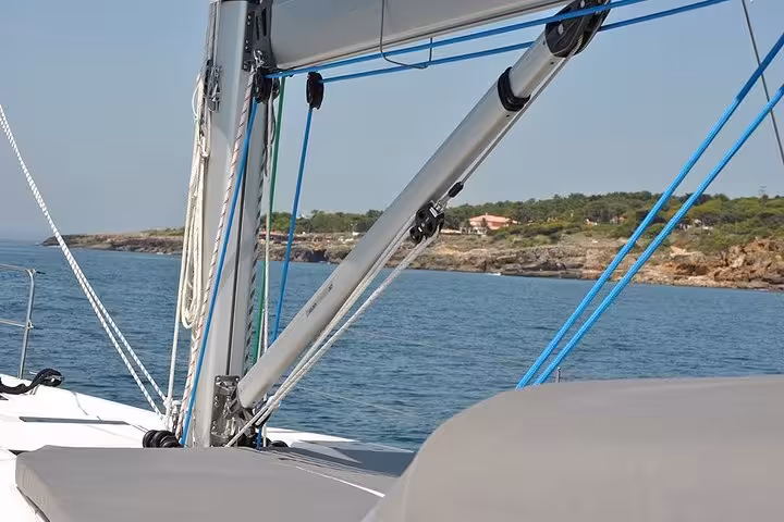 Sailing yacht deck and rigging cruising along Cascais coastline on a private half-day or full-day sailing tour