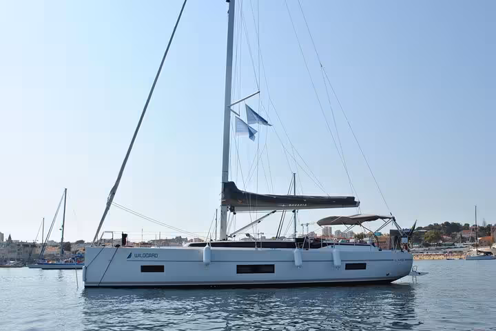 Modern sailing yacht in Cascais marina, ideal for a private 2-hour sunset cruise with drinks on board
