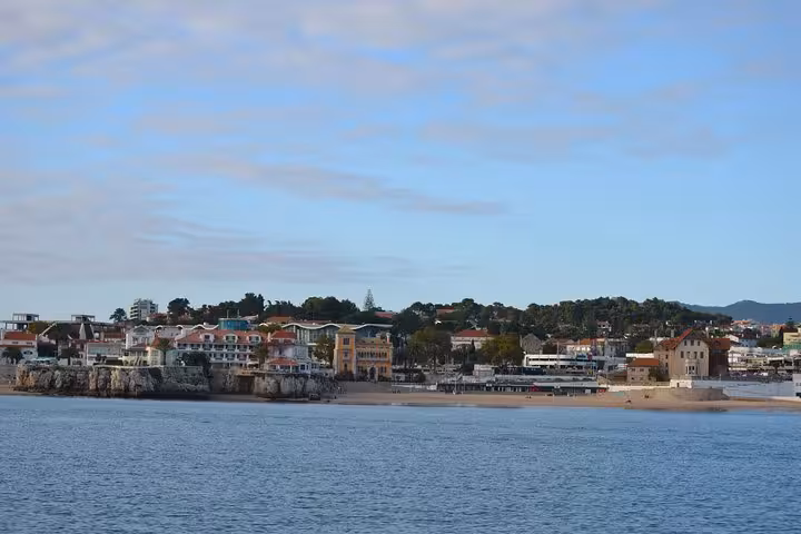 Coastal Cascais and sandy beach seen from a 2-hour private sailing tour, Atlantic views with drinks on board