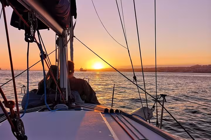 Sunset view from sailboat deck on a romantic private 2-hour Cascais cruise with sparkling wine on the Atlantic