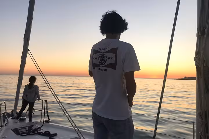 Couple enjoying golden-hour ocean views on a Cascais sunset private 2-hour sailboat cruise with drinks