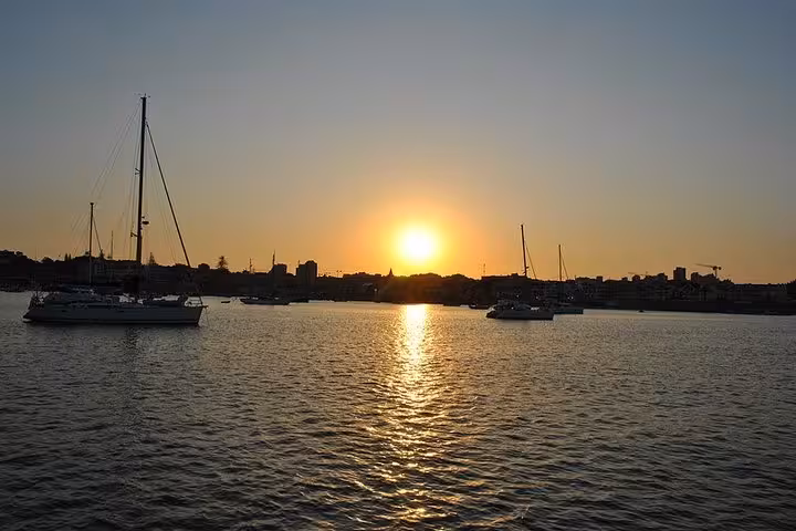 Sunset over Cascais bay with sailboats, scenic private 2h cruise with drinks along the Portuguese coast