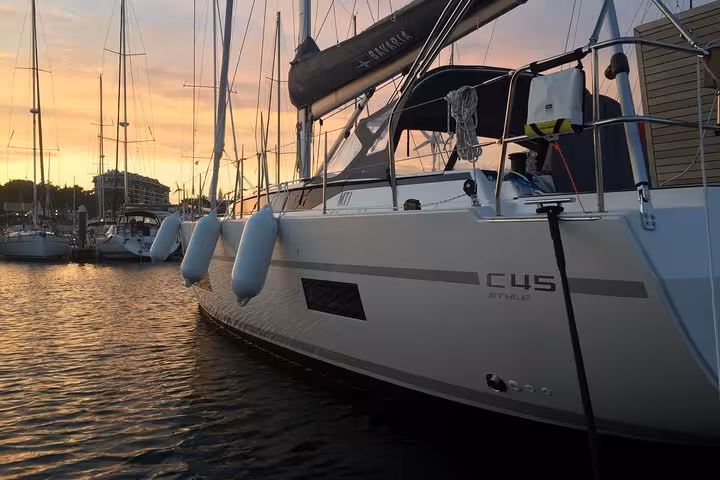 Sailboat moored at Cascais marina at golden hour, private 2h sunset cruise yacht with drinks included