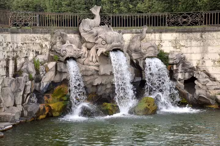 Baroque dolphin fountain in the royal gardens of the Palace of Caserta, visited on a guided small-group tour in Italy