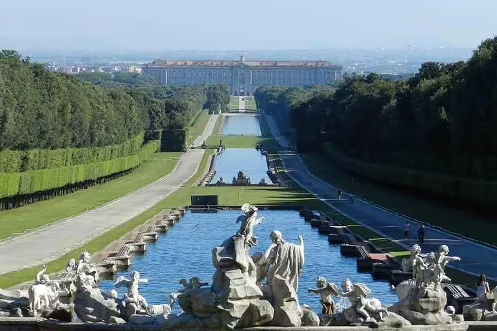 Panoramic view of Caserta Royal Palace, cascading fountains and formal gardens seen on a full-day private tour from Naples