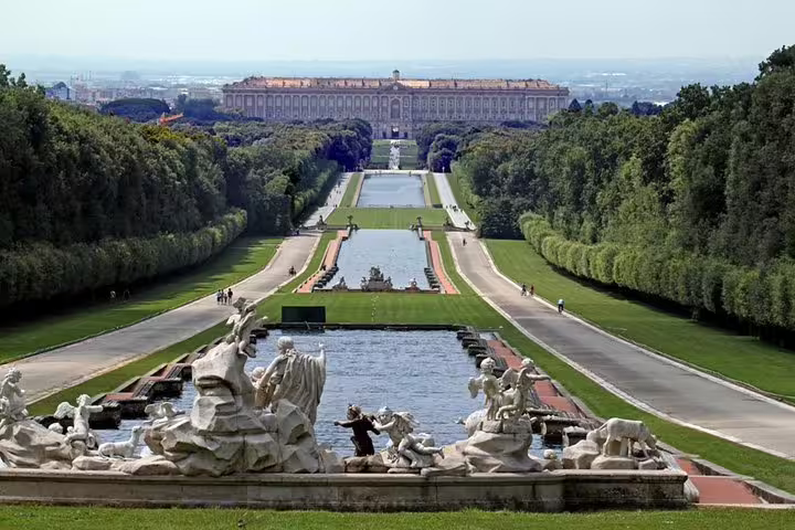 Panoramic view of Caserta Royal Palace gardens with fountains and statues, featured on a full-day private palace tour