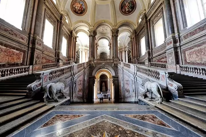 Majestic marble staircase and ornate baroque hall inside Caserta Royal Palace, included in an exclusive private tour