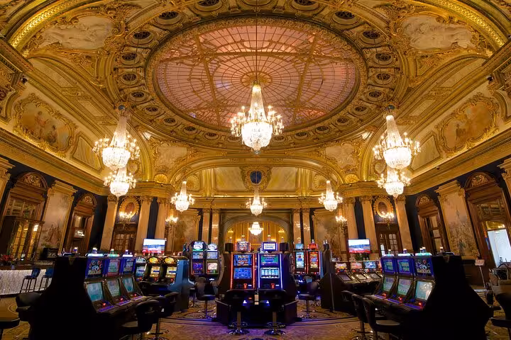 Stunning chandeliers and slot machines adorn the lavish interior of Casino de Monte-Carlo in Monaco.