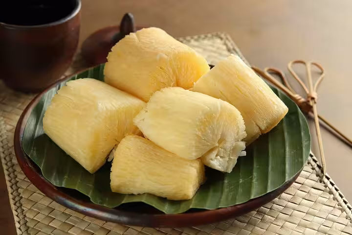 Freshly cooked cassava served on a banana leaf, a traditional Brazilian dish featured in our Rio cooking class.
