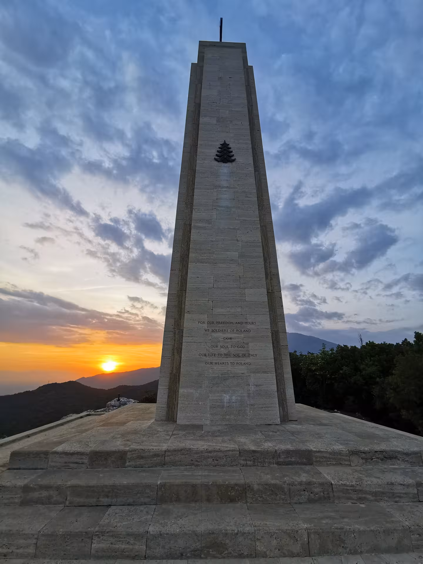 Sunset view of a tall monument at Cassino, Italy, highlighting the historical significance of the Red Poppy tour.