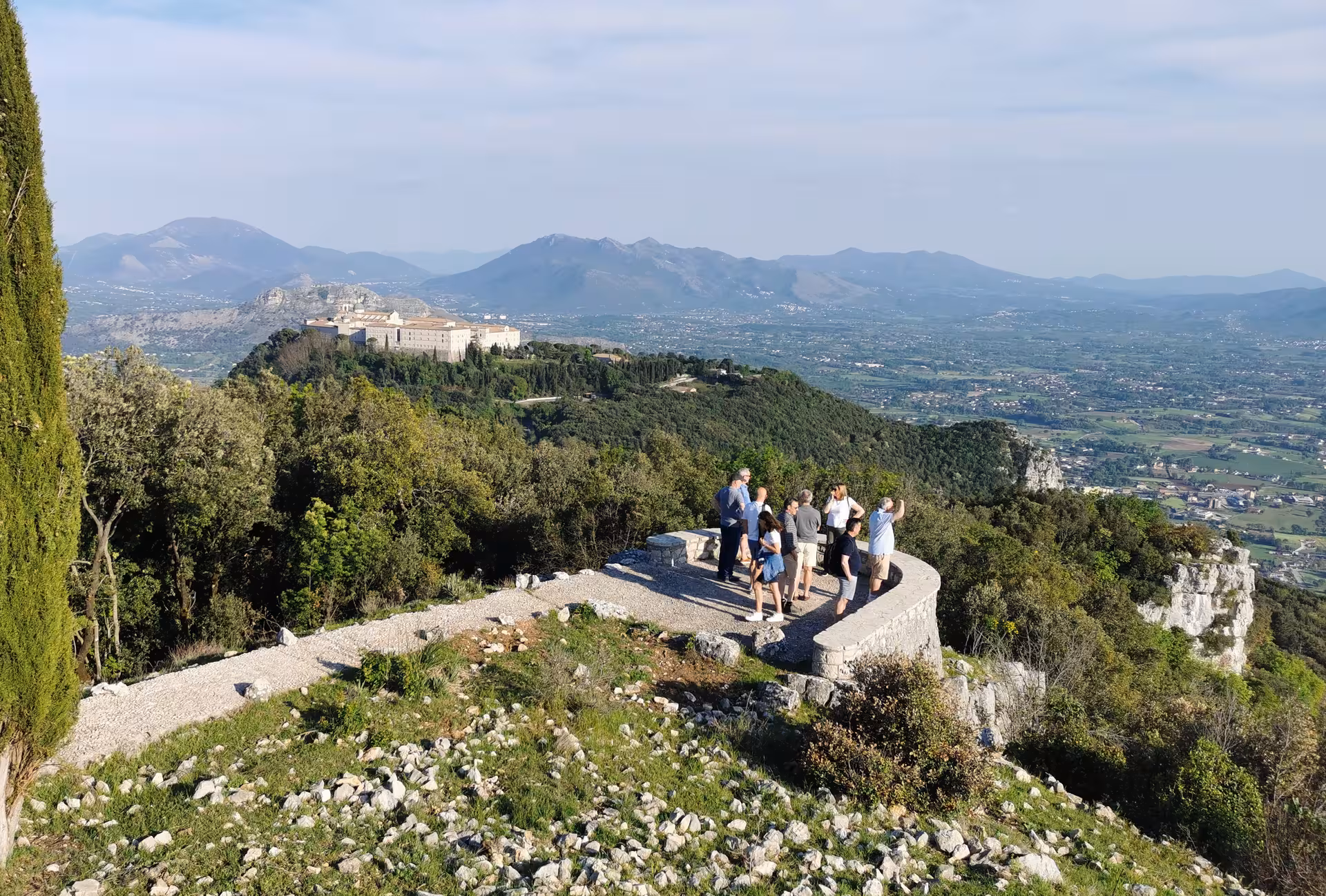 Group of tourists enjoying panoramic views near Monte Cassino Abbey on a guided walking tour experience.