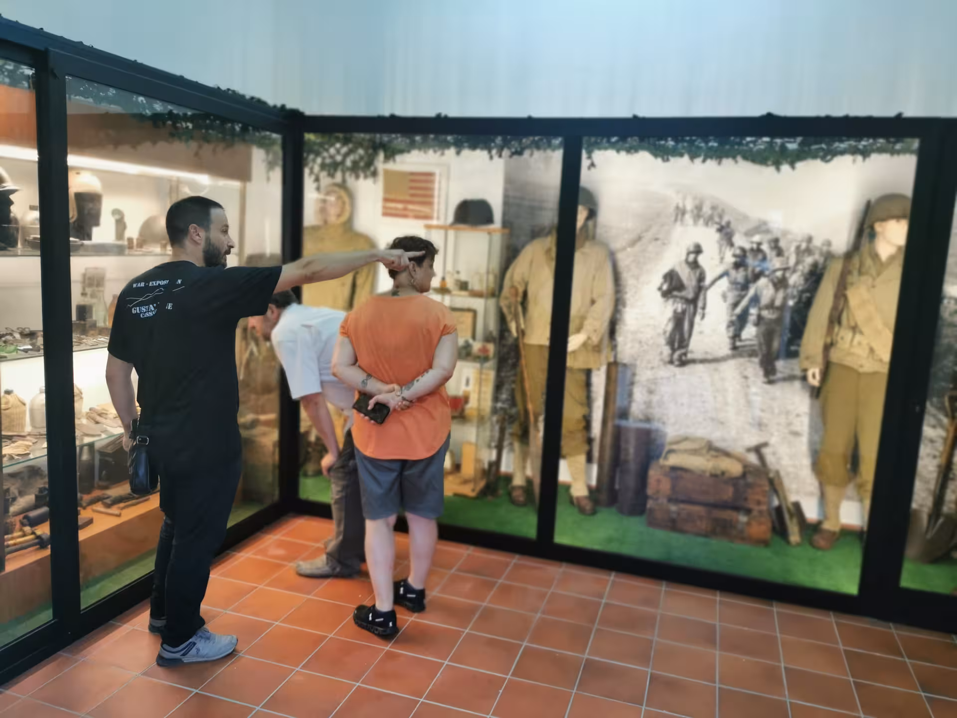 Visitors engage with historical WWII exhibits during the Cassino Red Poppy tailor-made museum tour.