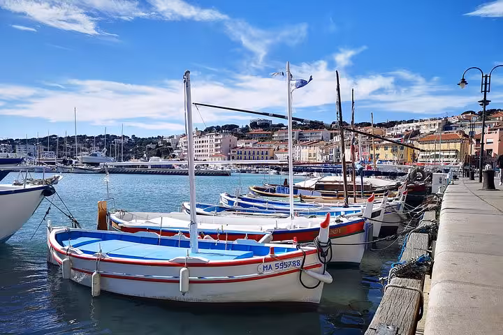 Cassis harbor with colorful boats on turquoise water, scenic stop on private shore excursion from Arles