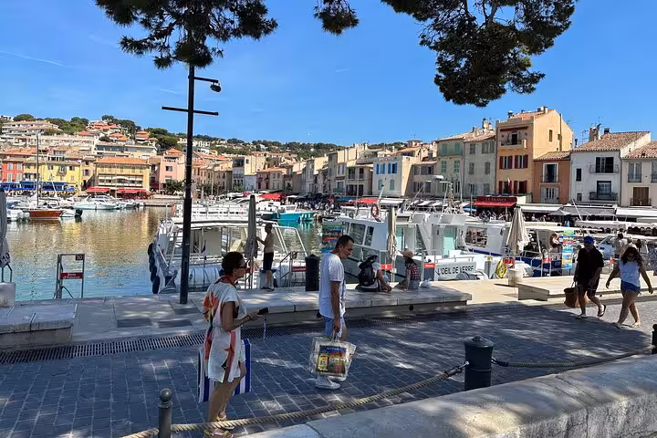 Cassis harbor waterfront with colorful buildings and boats, stop on private Cassis and Marseille city tour