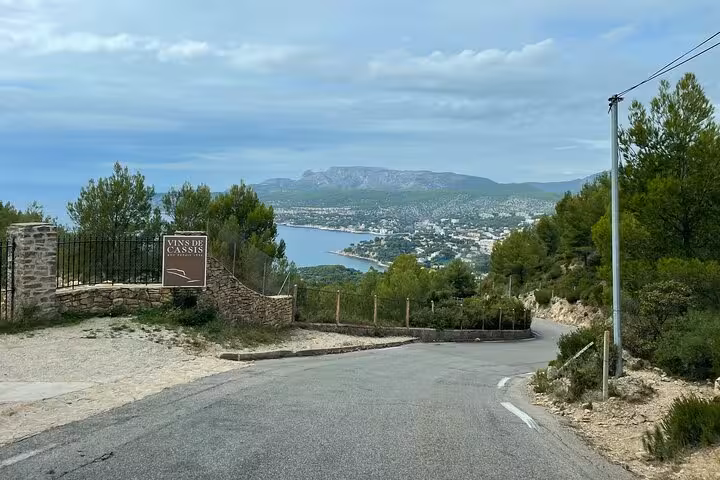 Scenic drive above Cassis with sea views near Vins de Cassis sign on a private Cassis and Marseille tour