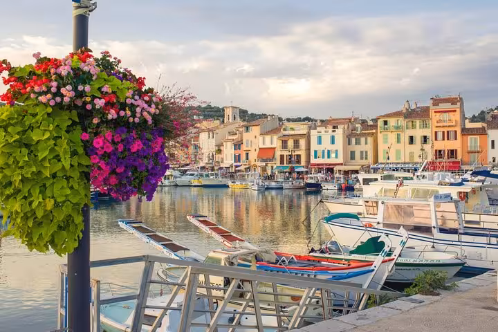Charming waterfront view of Cassis village with colorful buildings and yachts, ideal for a private tour experience.