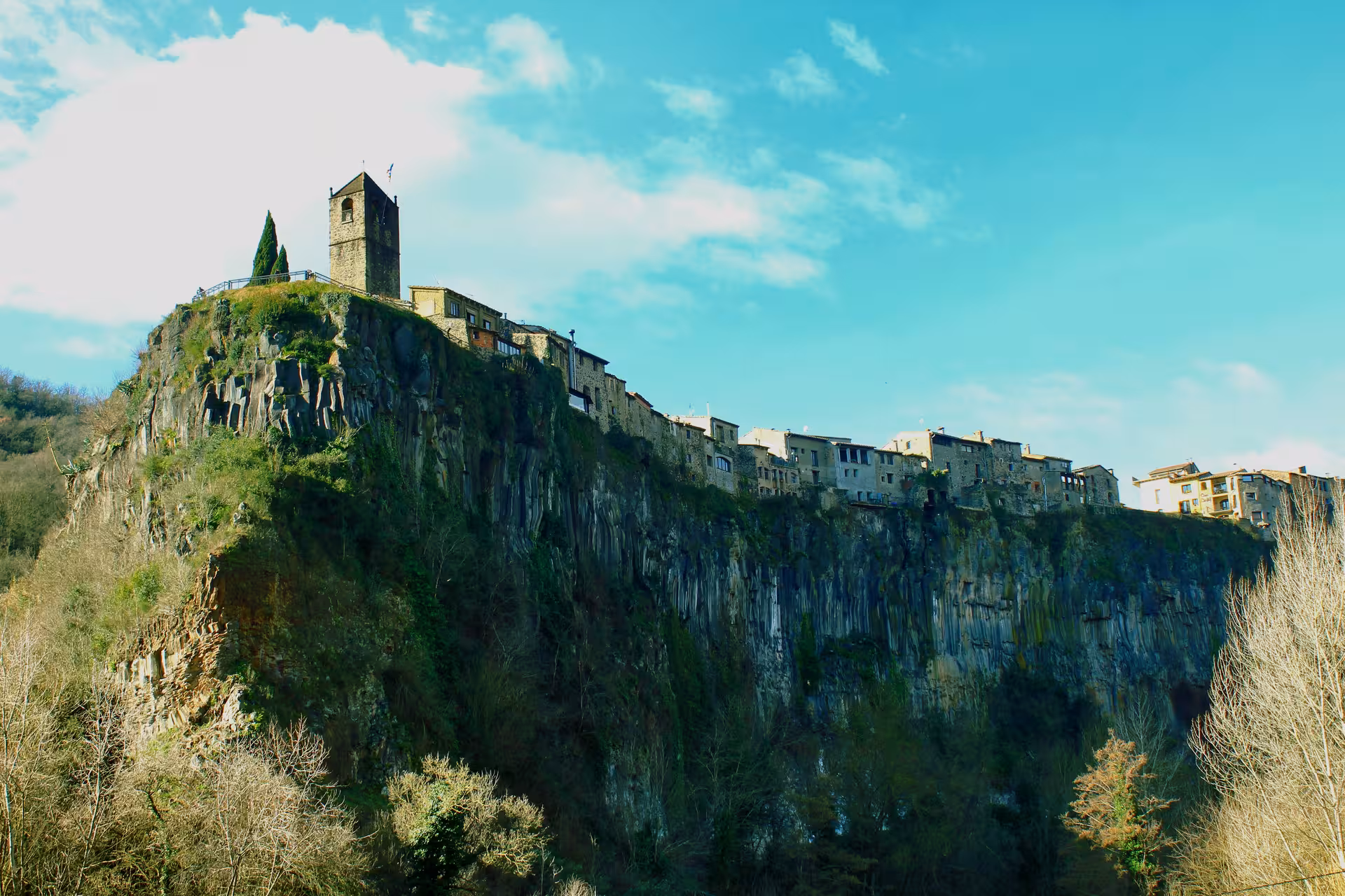 Castellfollit de la Roca perched on basalt cliffs in Garrotxa, Catalonia, highlight stop on private excursion