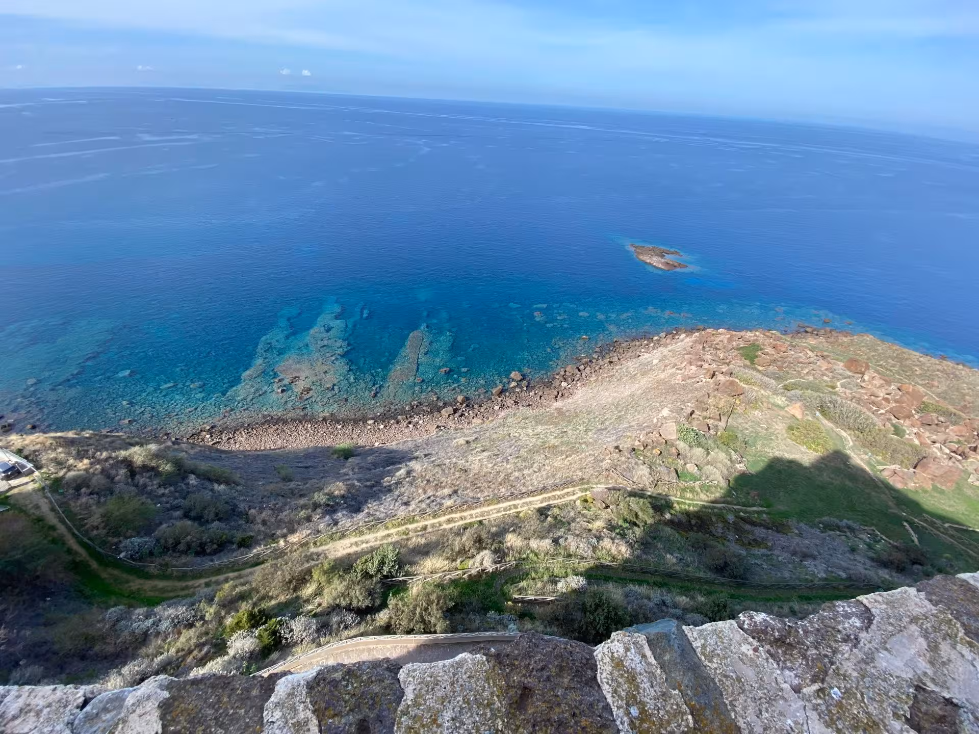Breathtaking panoramic view of Castelsardo coastline with clear blue waters and rugged shoreline.