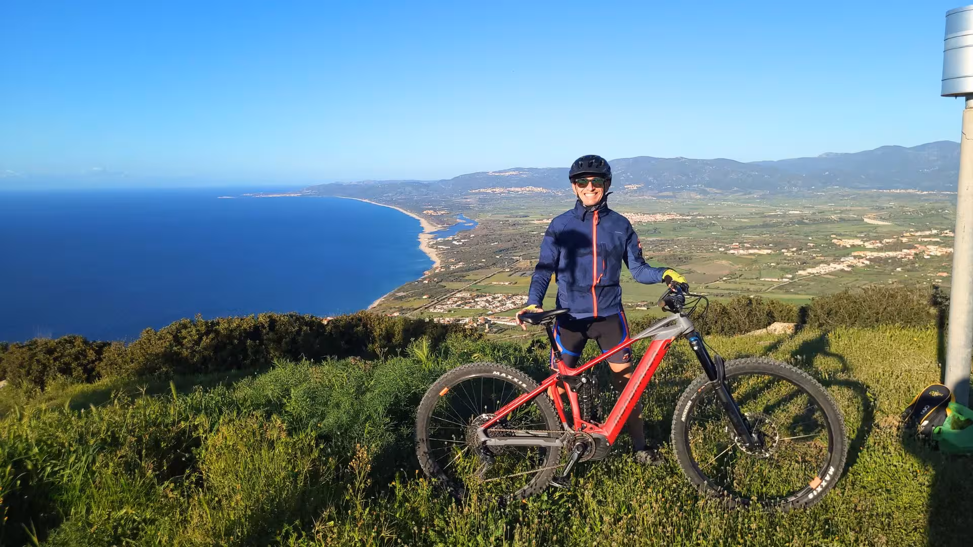 Cyclist with an ebike enjoys stunning coastal views during a Castelsardo panoramic ebike tour.