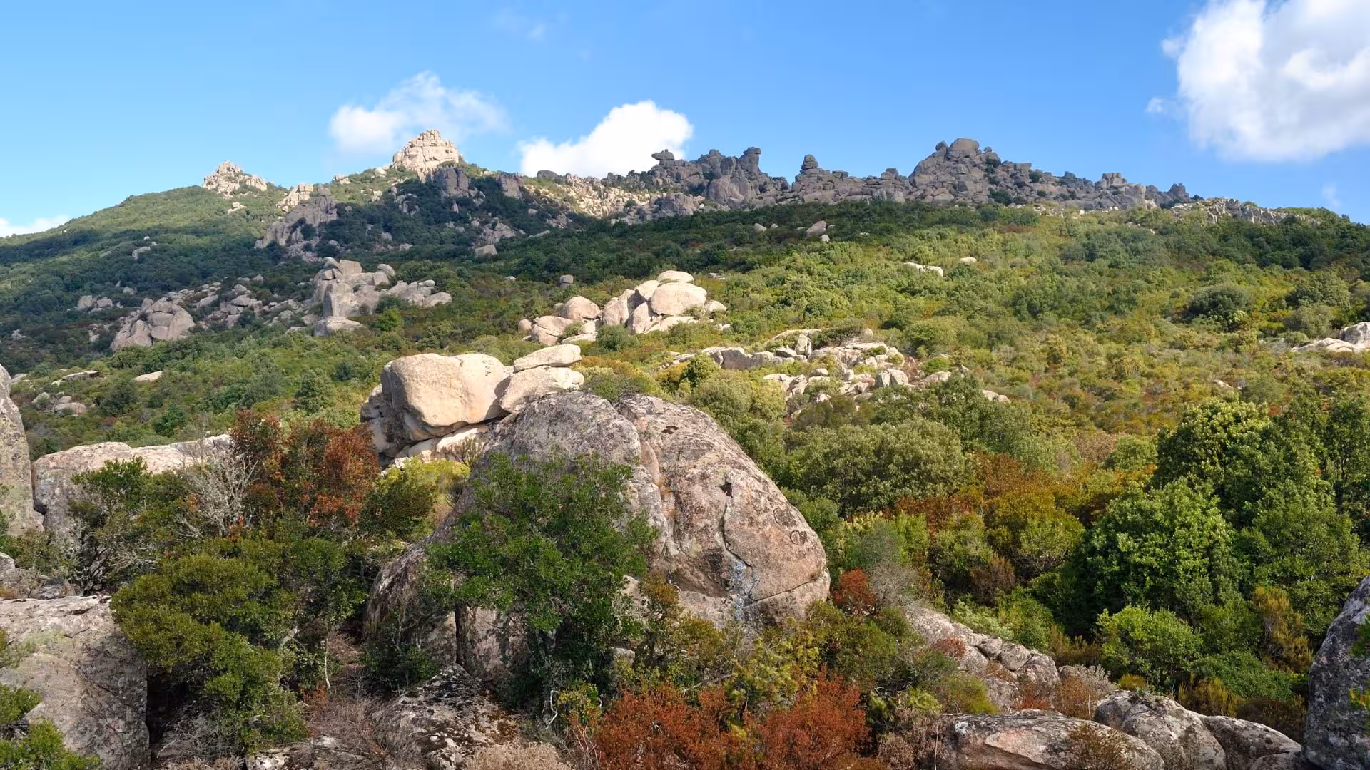 Scenic view of rocky hills and lush greenery in S'Acqua Callenti forest, ideal for trekking in Castiadas.