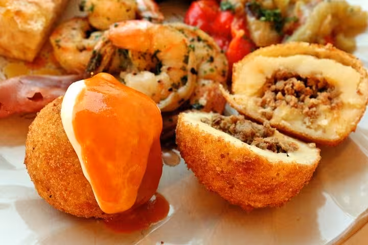 Savor delicious Catalan croquettes with shrimp and peppers on the Hidden Gràcia Food Tour in Barcelona.