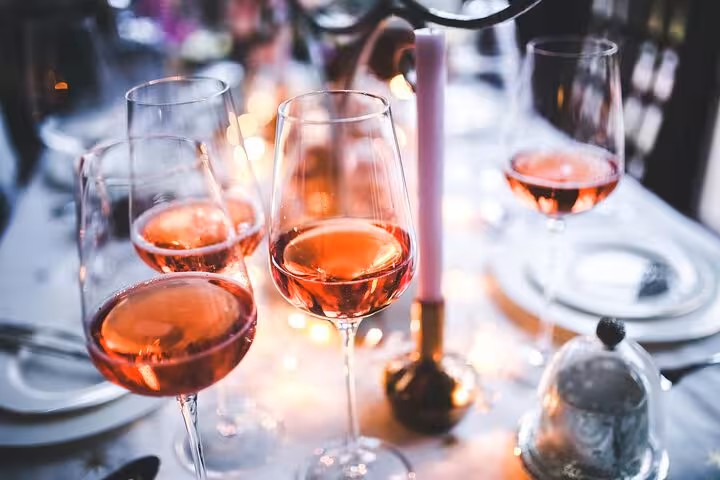 Enjoy a selection of rosé wine glasses elegantly arranged, highlighting the Catalan wine culture in Gràcia, Barcelona.