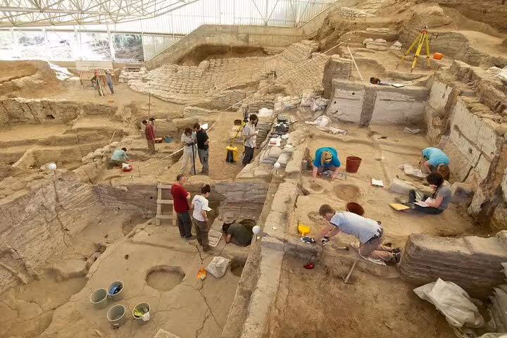 Archaeologists excavating the Neolithic ruins at Çatalhöyük near Konya on a private day tour with lunch