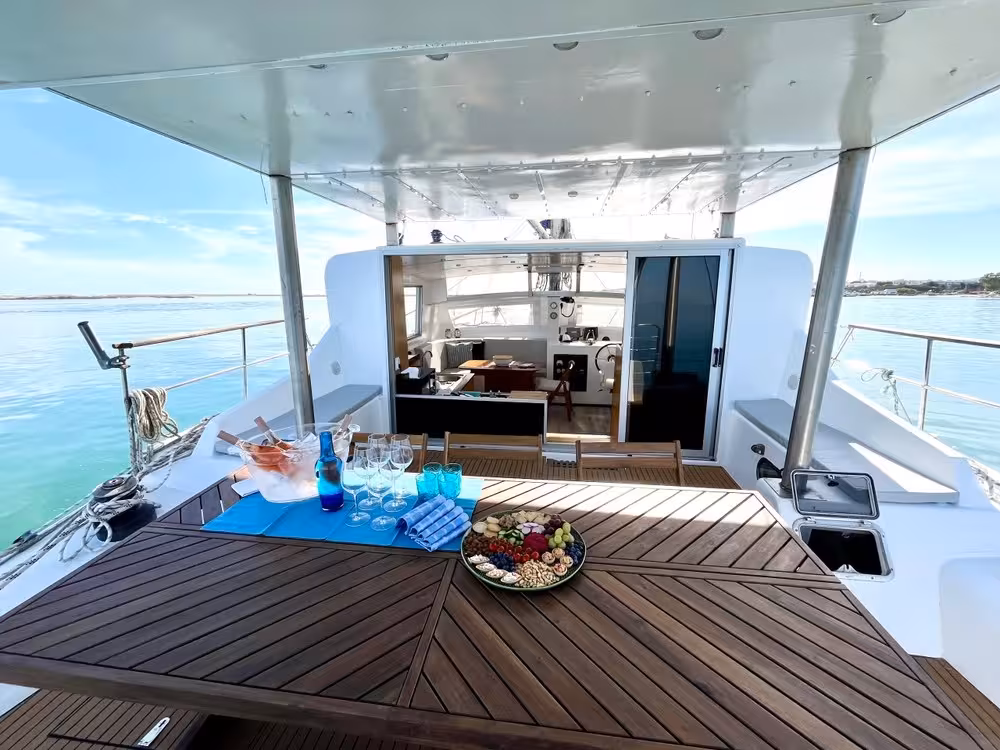 Catamaran aft deck set with drinks and snacks at the Blue Lagoon, perfect for a half-day sailing cruise and swim stop