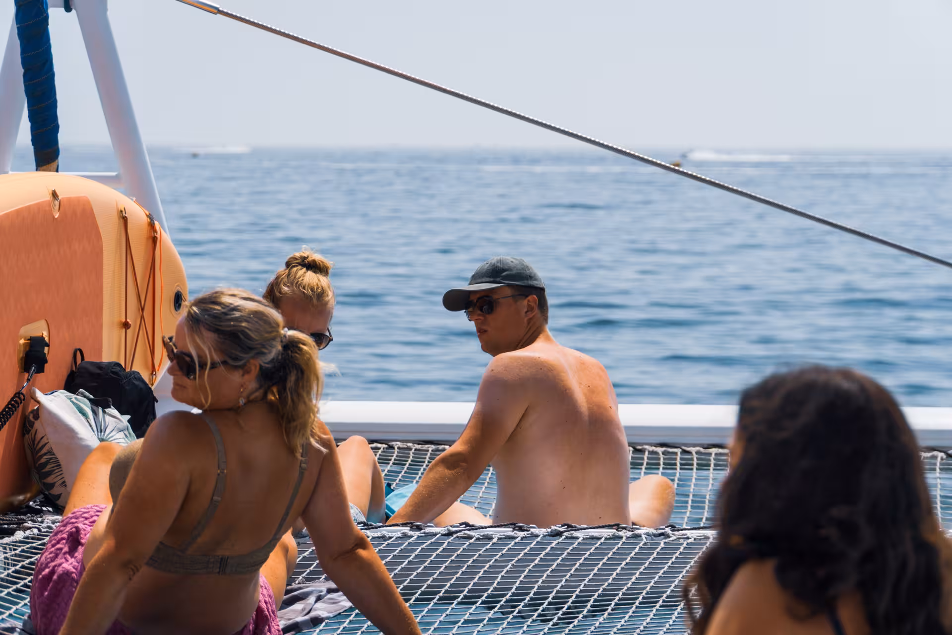 Guests enjoying a lively catamaran boat tour in Lagos Algarve with drinks and music on sunny waters