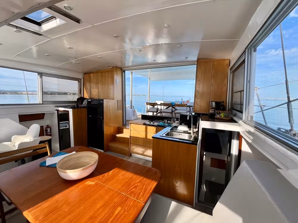 Modern catamaran cabin with kitchen and lounge, bright windows and sea views for Half Day Sail Catamaran Blue Lagoon