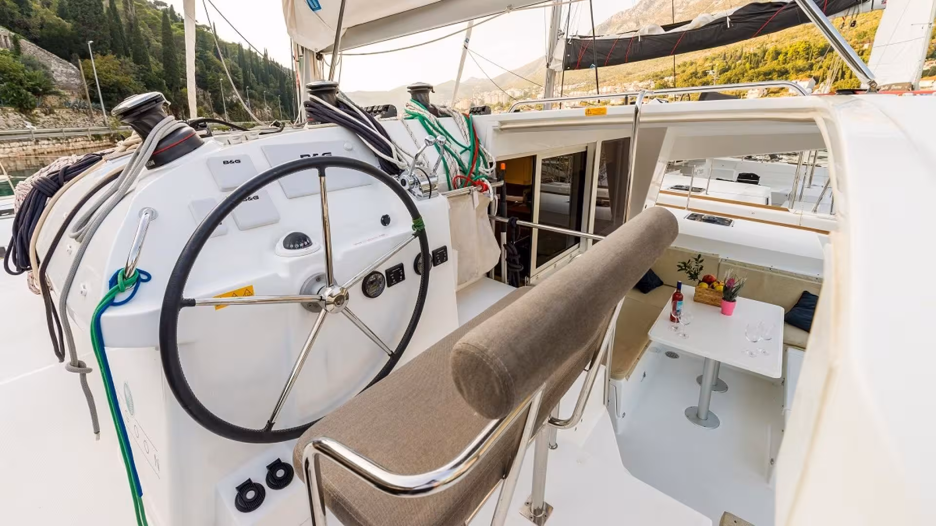 Catamaran helm with seating and dining area, ready for a scenic tour in Tavolara Marine Protected Area.