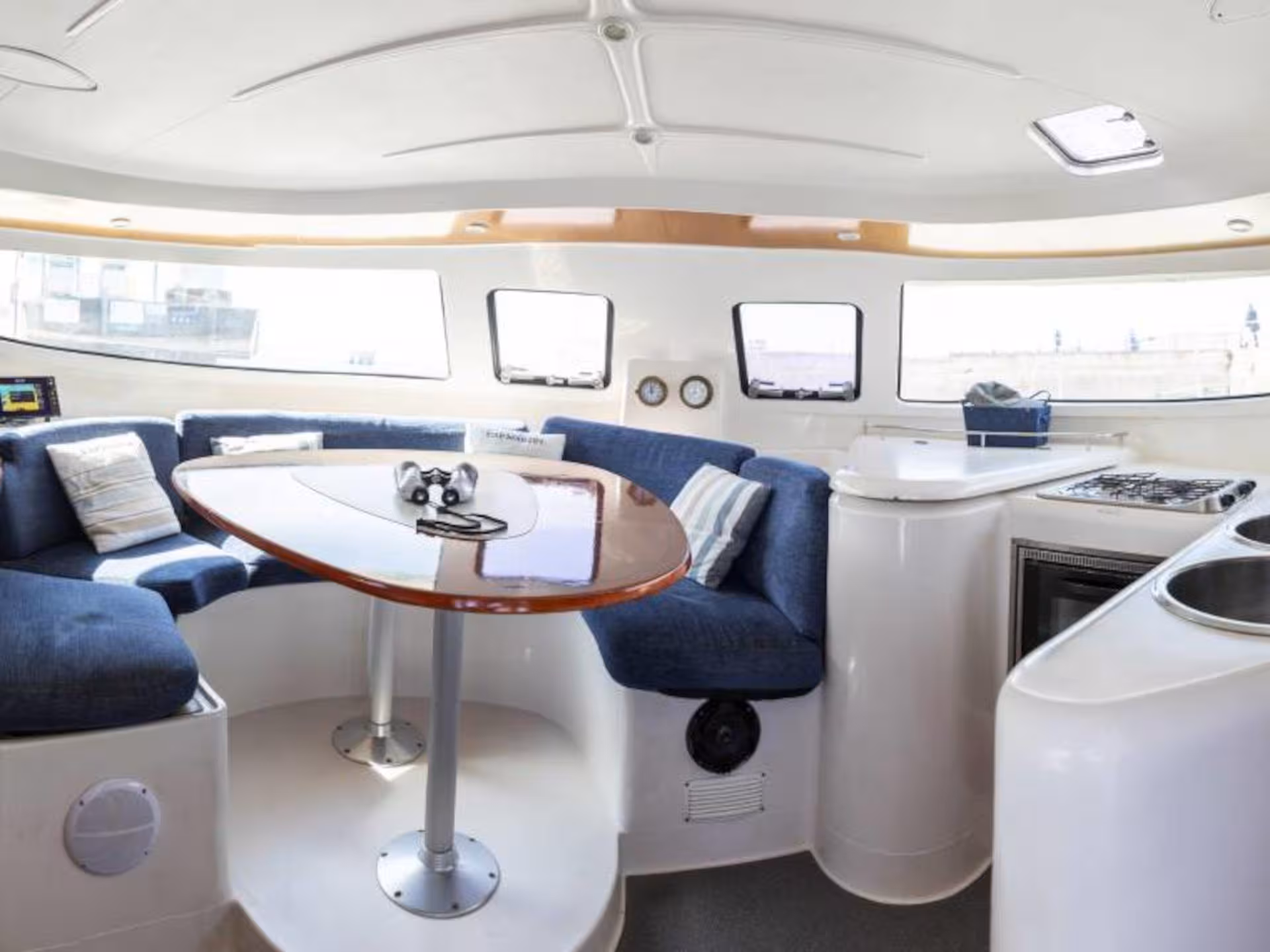 Spacious catamaran interior with cozy seating and modern amenities on a La Maddalena Archipelago tour.