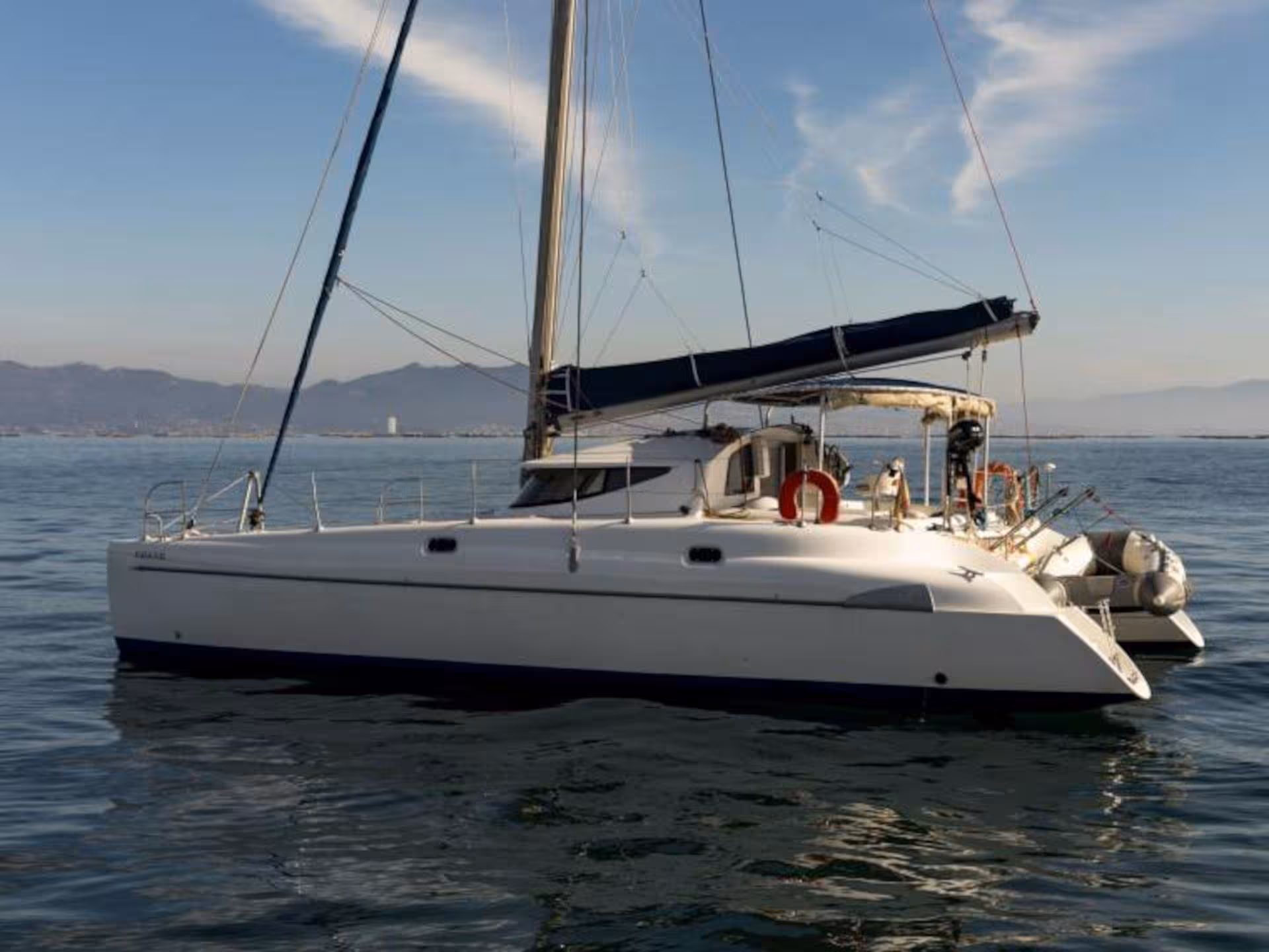 Sleek catamaran anchored in calm waters, perfect for exploring the scenic beauty of La Maddalena Archipelago.