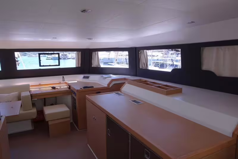Bright interior lounge of a modern catamaran with large windows and harbor views for a comfortable Gulf of Naples day cruise