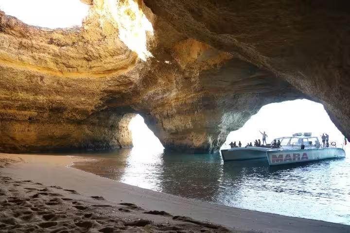 Catamaran MARA anchored inside a magnificent cave, offering breathtaking views of the Algarve coastline.
