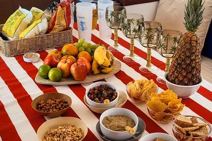 Onboard snacks and tropical fruit spread served on Velas do Rio shared 3-hour catamaran sailboat cruise