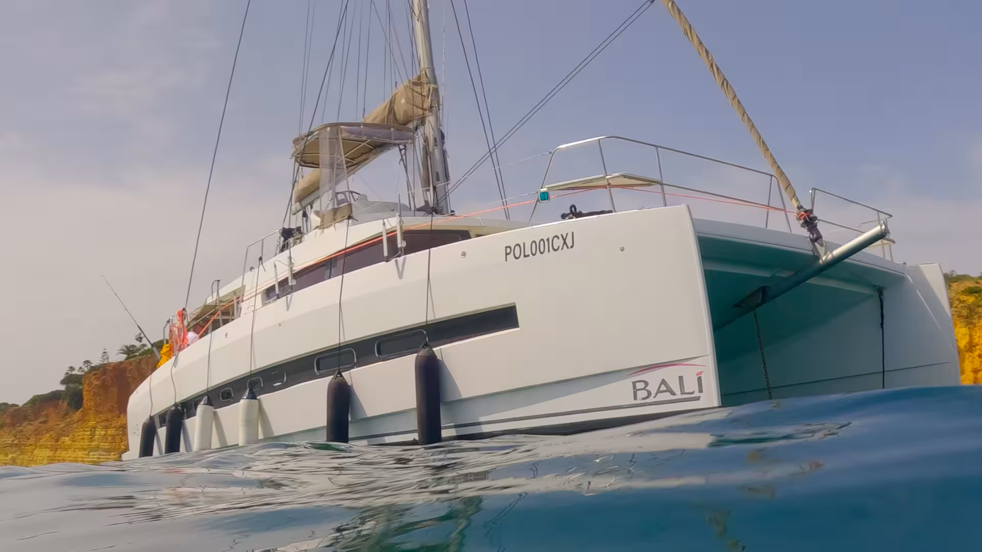 Bali catamaran hull on Algarve coast near Lagos, ideal for sunset cruise with sea cave views and calm waters