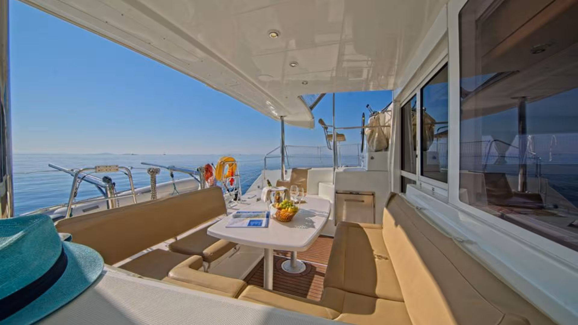 Spacious outdoor seating area on a catamaran in Tavolara Marine Protected Area, ideal for enjoying a scenic sail.