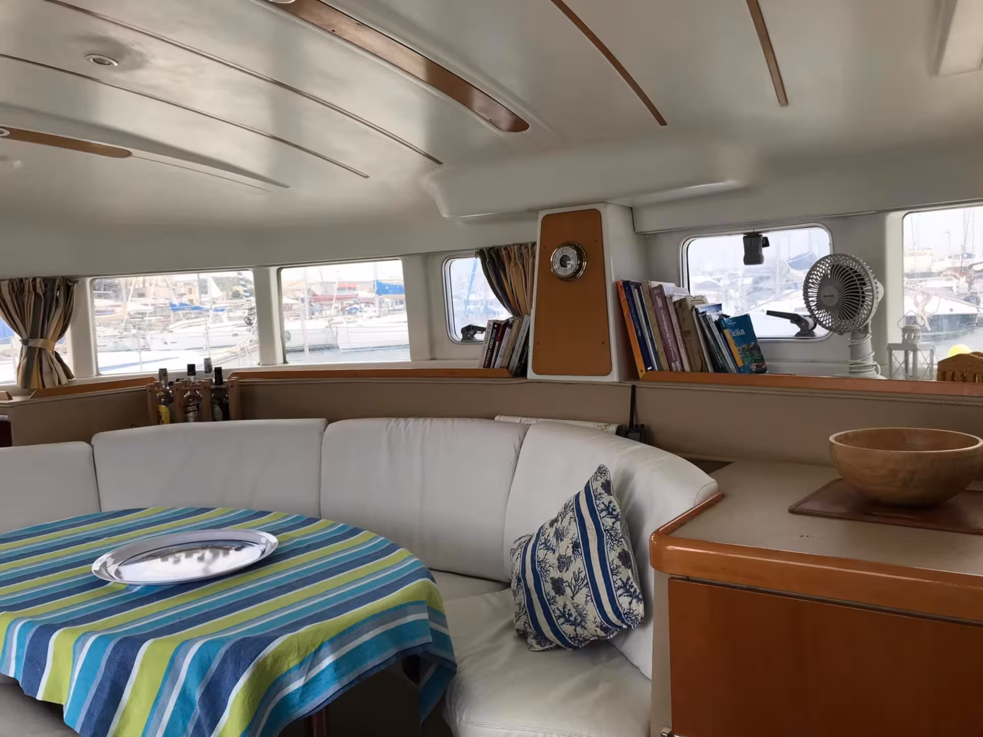 Spacious catamaran interior with cozy seating and scenic views on the Catamaran Tenerè tour, La Maddalena Archipelago.