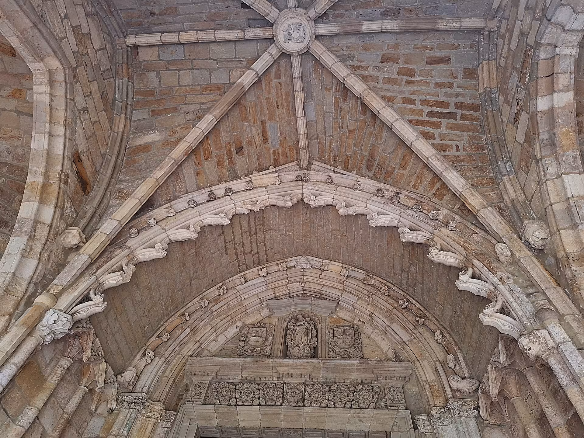 Intricate stone carvings and vaulted ceiling in the Cathedral of Santander displaying exquisite architectural detail.