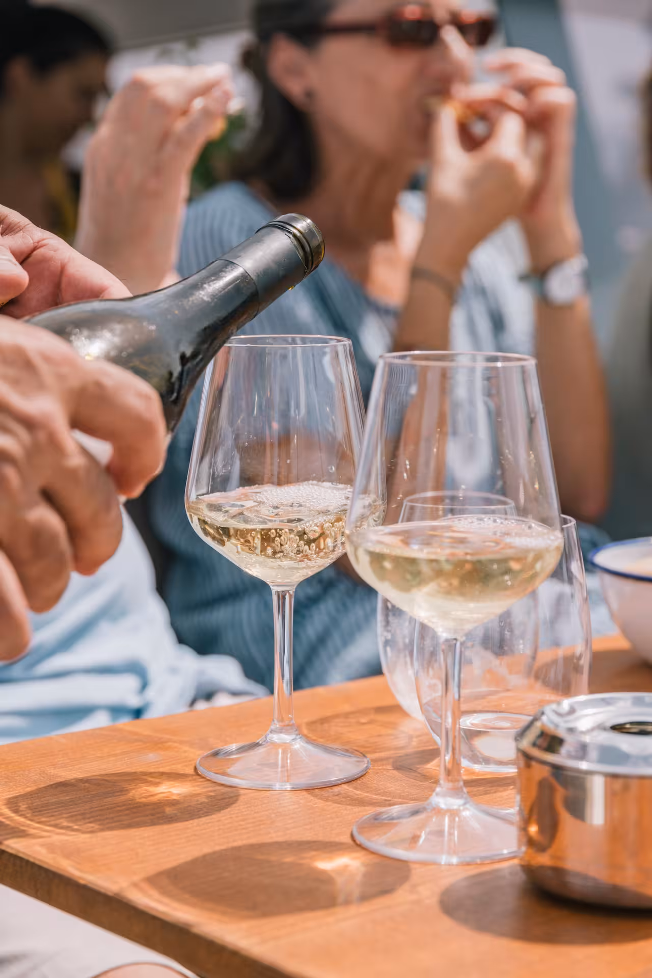Cava poured into wine glasses on a private luxury Bali 4.1 catamaran cruise in Barcelona