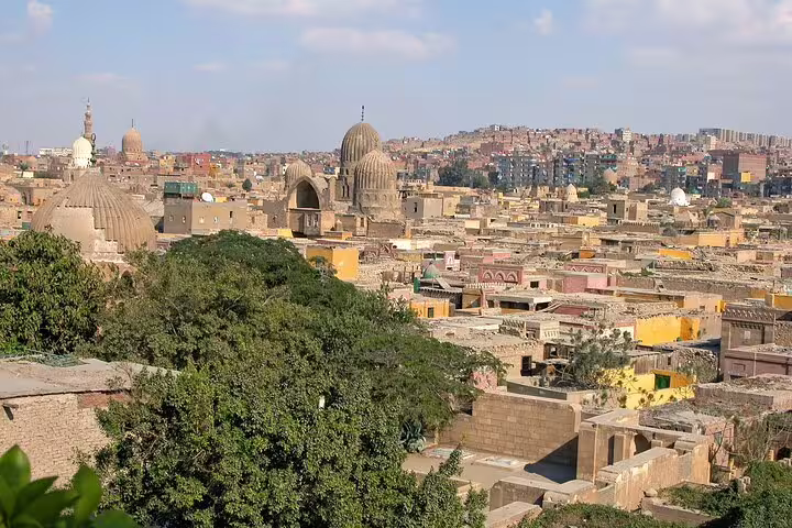 Panoramic City of the Dead Cairo skyline with domed mausoleums on Cave Church and necropolis tour