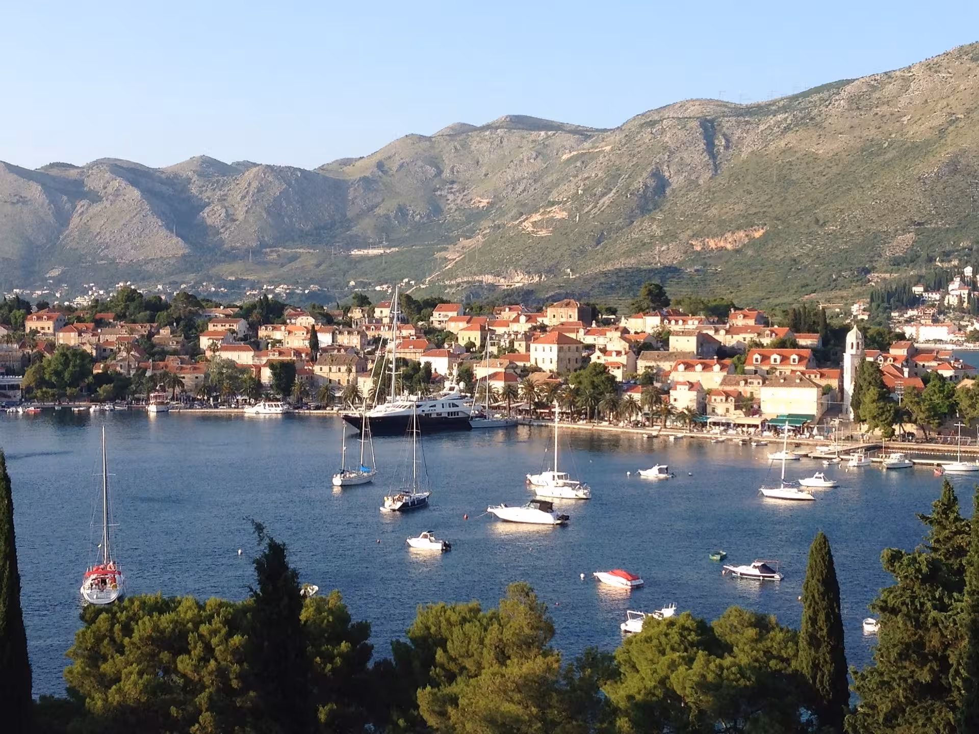Panoramic view of Cavtat harbor with sailboats and red roofs, scenic stop on Konavle and Cavtat tour
