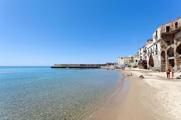 Golden sand beach and clear Tyrrhenian Sea in Cefalù, Sicily, seen on a private coastal tour from Palermo